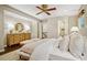Bright main bedroom with a large bed, a dresser with lamps, and an ensuite bathroom entrance at 3932 Granger Dr, Brookhaven, GA 30341