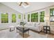Inviting sunroom with skylights, large windows, neutral color palette, and a cozy seating area at 3932 Granger Dr, Brookhaven, GA 30341