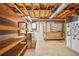 Unfinished basement area for storage with exposed ceiling, fridge and shelving units at 3932 Granger Dr, Brookhaven, GA 30341