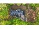 An aerial view of a house surrounded by lush trees and a long driveway at 4703 Waverly Walk, Douglasville, GA 30135