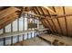 Unfinished attic featuring exposed wood and beams, work benches, and plywood flooring at 4703 Waverly Walk, Douglasville, GA 30135