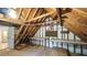 Unfinished attic with exposed wood framing, work benches, and doorway access at 4703 Waverly Walk, Douglasville, GA 30135