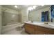 Bright bathroom featuring a dual sink vanity, bathtub and toilet at 4703 Waverly Walk, Douglasville, GA 30135