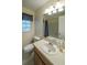 Bright bathroom featuring a large mirror, vanity with a sink and a toilet at 4703 Waverly Walk, Douglasville, GA 30135