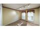 Cozy bedroom with carpeted floors and two windows offering plenty of natural light at 4703 Waverly Walk, Douglasville, GA 30135