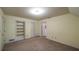 Neutral bedroom featuring carpeted floors, built in shelving, and access to the ensuite bathroom at 4703 Waverly Walk, Douglasville, GA 30135