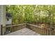 Outdoor deck with wooden railing offers scenic views of the surrounding wooded area at 4703 Waverly Walk, Douglasville, GA 30135