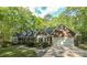 Charming brick home featuring bay windows, an attached garage and mature trees at 4703 Waverly Walk, Douglasville, GA 30135