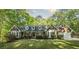 Charming brick home featuring bay windows and a well-manicured lawn with mature trees at 4703 Waverly Walk, Douglasville, GA 30135