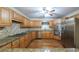 Spacious kitchen featuring stainless steel appliances, wood cabinets, and granite countertops at 4703 Waverly Walk, Douglasville, GA 30135