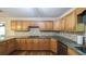 Kitchen featuring stainless steel appliances, wood cabinets, granite countertops and decorative tile backsplash at 4703 Waverly Walk, Douglasville, GA 30135