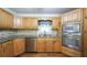 Kitchen featuring stainless steel appliances, granite countertops, wood cabinets and decorative tile backsplash at 4703 Waverly Walk, Douglasville, GA 30135