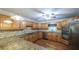 Kitchen featuring stainless steel appliances, granite countertops, wood cabinets and pendant lighting at 4703 Waverly Walk, Douglasville, GA 30135