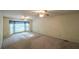 Spacious main bedroom with carpeting, two ceiling fans and a large window at 4703 Waverly Walk, Douglasville, GA 30135