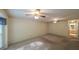Spacious main bedroom featuring carpeting, two ceiling fans and a doorway to the bathroom at 4703 Waverly Walk, Douglasville, GA 30135