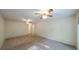 Spacious main bedroom featuring carpeting, two ceiling fans and doorway at 4703 Waverly Walk, Douglasville, GA 30135