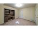 Carpeted room with built-in bookshelves, cabinets and desk space at 4703 Waverly Walk, Douglasville, GA 30135