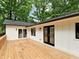 Spacious wooden back deck featuring black-framed windows and doors, perfect for outdoor entertaining at 5840 Crabapple Sw Dr, Mableton, GA 30126
