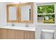 Bright bathroom with a double vanity and large window offering an amazing view of green space at 5840 Crabapple Sw Dr, Mableton, GA 30126