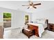Bright bedroom featuring a ceiling fan, two windows with a great view, and warm wooden furniture at 5840 Crabapple Sw Dr, Mableton, GA 30126