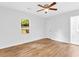 Bedroom featuring hardwood floors, a window with natural views, and a ceiling fan at 5840 Crabapple Sw Dr, Mableton, GA 30126