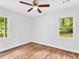 Bedroom with hardwood floors, two windows, and a ceiling fan at 5840 Crabapple Sw Dr, Mableton, GA 30126