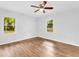 This bedroom features hardwood floors, two windows, and a ceiling fan at 5840 Crabapple Sw Dr, Mableton, GA 30126