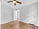 Bedroom with hardwood floors, ceiling fan, two doors, and a window at 5840 Crabapple Sw Dr, Mableton, GA 30126