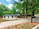 Exterior shot of a one story home featuring a long driveway, front lawn, and inviting covered porch area at 5840 Crabapple Sw Dr, Mableton, GA 30126