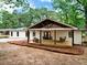 Charming single-story home with a lovely covered front porch and swing, offering a welcoming curb appeal at 5840 Crabapple Sw Dr, Mableton, GA 30126