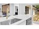 Kitchen sink with stone countertops and access to the outdoor deck through sliding glass doors at 5840 Crabapple Sw Dr, Mableton, GA 30126
