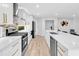Contemporary kitchen featuring marble countertops, stainless steel appliances, and an island sink at 5840 Crabapple Sw Dr, Mableton, GA 30126