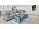 Bright living room featuring a plush gray sofa and stylish decor accents at 5840 Crabapple Sw Dr, Mableton, GA 30126
