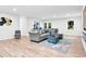 Spacious living room with a comfortable sofa, light hardwood flooring, and modern decor at 5840 Crabapple Sw Dr, Mableton, GA 30126