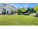 Beautifully landscaped backyard featuring a manicured lawn, pool, and outdoor seating area at 210 Tifton Ln, Roswell, GA 30075