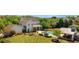 Expansive backyard featuring a pool, outdoor dining area, pool house and landscaped gardens at 210 Tifton Ln, Roswell, GA 30075