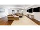 Finished basement featuring hardwood floors, comfortable sectional sofa, and multiple TV screens on the wall at 210 Tifton Ln, Roswell, GA 30075