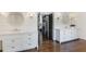 Bright primary bathroom with double vanities, shiplap accent wall, and dark hardwood floors at 210 Tifton Ln, Roswell, GA 30075