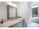 Bright bathroom featuring granite countertops, a large mirror, and natural light at 210 Tifton Ln, Roswell, GA 30075
