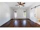Bright bedroom featuring hardwood floors, a ceiling fan and stylish sliding barn door leading to the bathroom at 210 Tifton Ln, Roswell, GA 30075