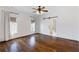 Bright bedroom featuring hardwood floors, a ceiling fan and stylish sliding barn door leading to the bathroom at 210 Tifton Ln, Roswell, GA 30075