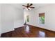 Bedroom with hardwood floors, modern lighting, and a view of the bathroom through the doorway at 210 Tifton Ln, Roswell, GA 30075