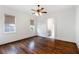 Spacious bedroom featuring hardwood floors, two windows, and an ensuite bathroom at 210 Tifton Ln, Roswell, GA 30075