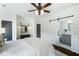 Bedroom featuring white wood plank walls, ceiling fan, barn door to bathroom, and furniture at 210 Tifton Ln, Roswell, GA 30075