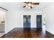 Bedroom featuring hardwood floors, shiplap walls, modern lighting, and two doors leading to the bathroom at 210 Tifton Ln, Roswell, GA 30075