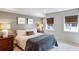 Cozy bedroom featuring natural light, neutral wall color, two windows, and a comfortable bed at 210 Tifton Ln, Roswell, GA 30075