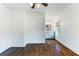 Bedroom with hardwood floors, modern lighting and a view of the bathroom with granite counters through the doorway at 210 Tifton Ln, Roswell, GA 30075