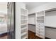 Closet with custom shelves, drawers, and rods with barn door access to bedroom at 210 Tifton Ln, Roswell, GA 30075