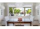 Charming dining area with view of pool, featuring a wooden table and bench seating at 210 Tifton Ln, Roswell, GA 30075