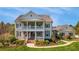 Charming two-story home with a welcoming front porch, manicured landscaping, and an American flag waving at 210 Tifton Ln, Roswell, GA 30075